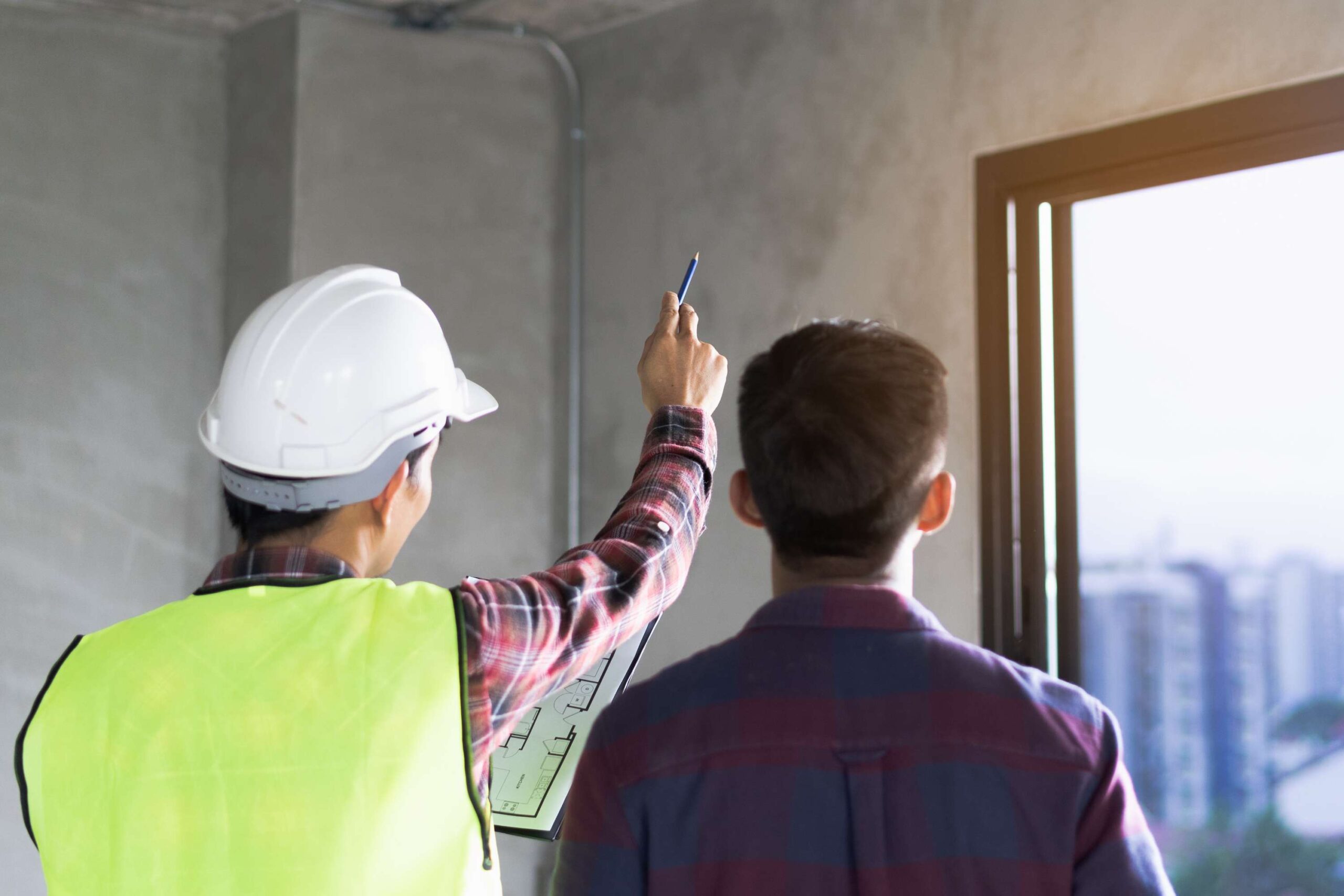 A renovation contractor reviews plans on-site to establish the scope of work and prepare a proposal that reflects the project's requirements.